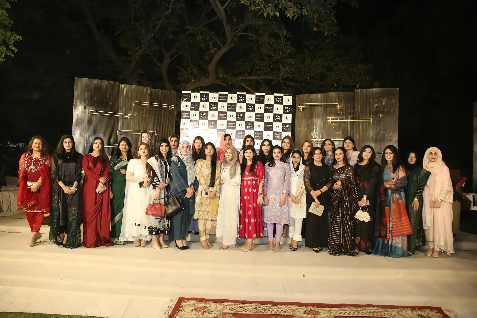 Group photo of CSS toppers at the annual dinner hosted by Read Right Institute at the Governor House in Lahore to celebrate the CSS result. The event, attended by successful CSS candidates, features mentor Syed Taimoor Bukhari. Attendees are dressed in formal attire, standing against a backdrop highlighting the 50th CTP. Keywords: CSS, Read Right Institute, mentor Syed Taimoor Bukhari, CSS result, annual dinner, Governor House, CSS toppers